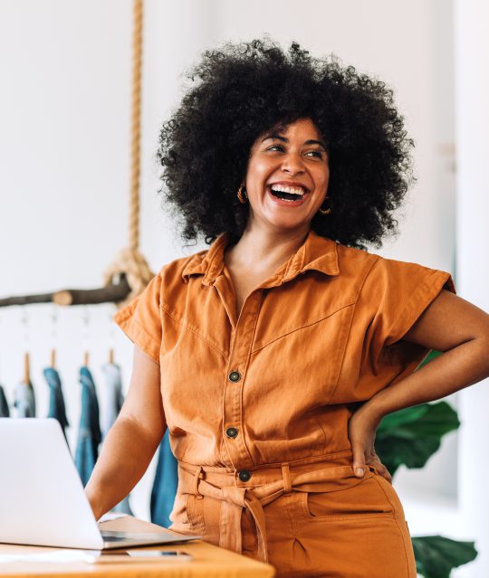 Women smiling together, representing friendly customer support and satisfaction with Smarter Payments Service
