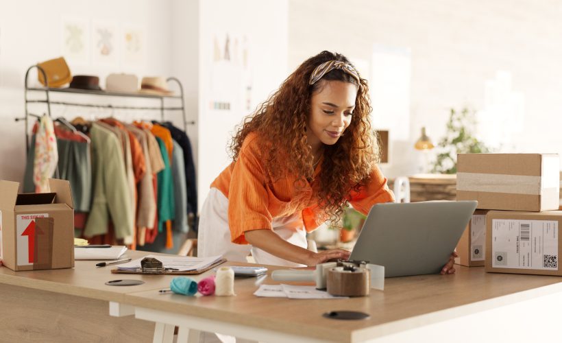 Business owner receiving customer support while processing a payment on her laptop for her services
