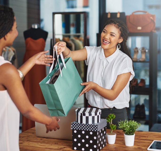Lady in retail taking payment of goods with a card machine