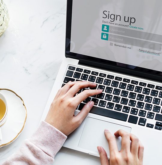 Person signing in to make payment on a laptop