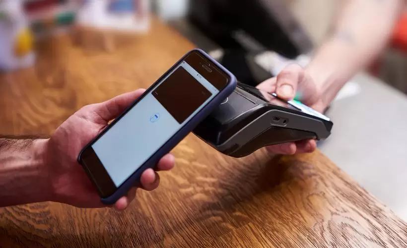modern card machine on a retail countertop, ready to accept contactless and mobile wallet payments