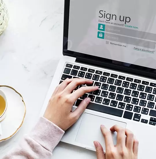 Person signing in to make payment on a laptop